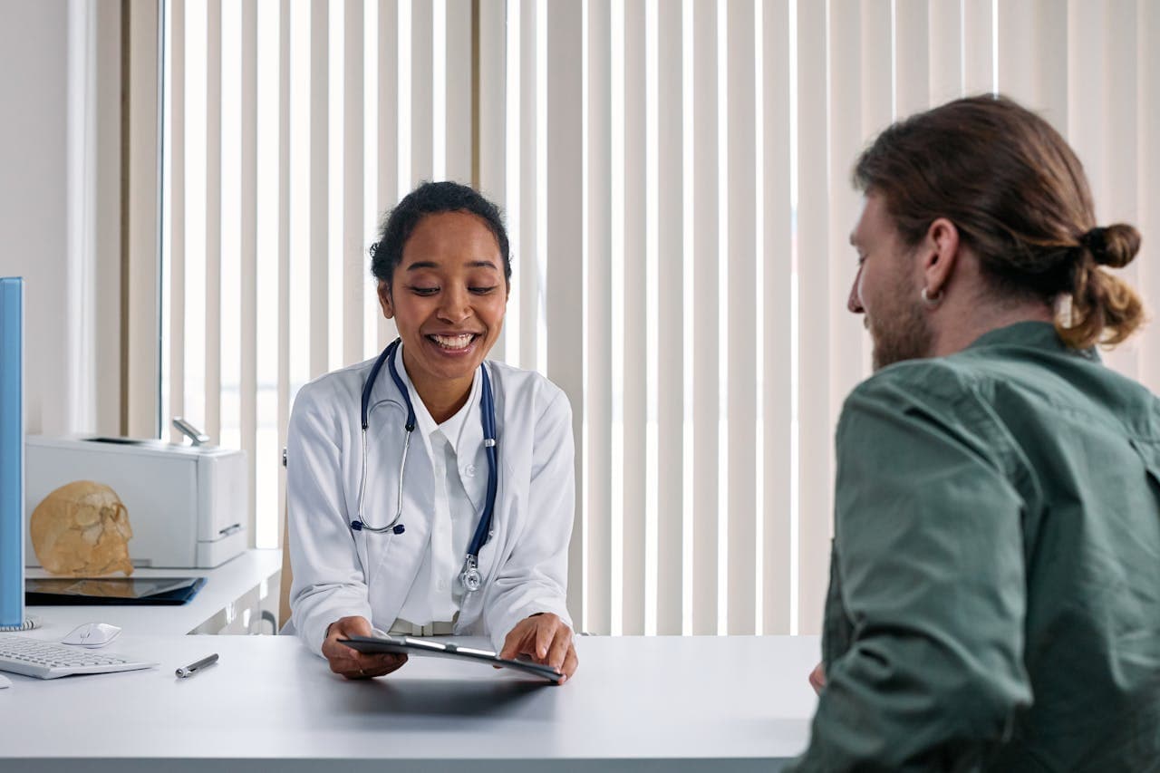 A physician consulting with a community member on Serve Day